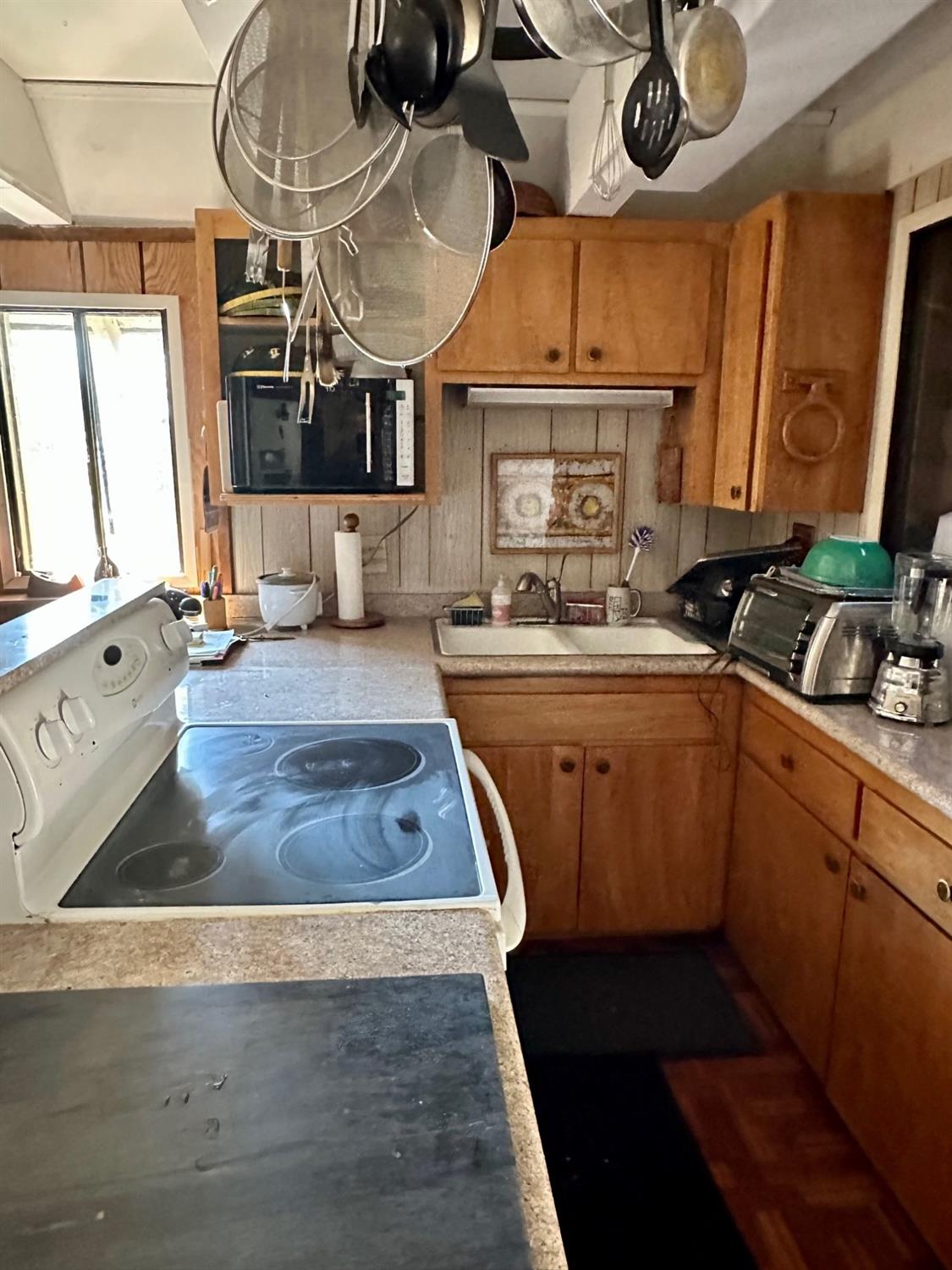 54758 Dinkey Creek Road Shaver Lake, CA 93664 - Photo 15 of 39 a kitchen with stainless steel appliances granite countertop a sink a stove and a wooden floors