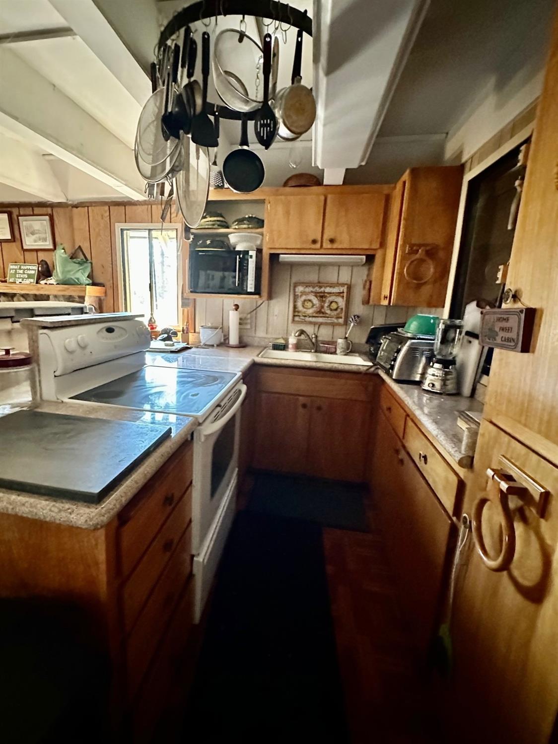54758 Dinkey Creek Road Shaver Lake, CA 93664 - Photo 18 of 39 a kitchen with a stove a sink and a stove