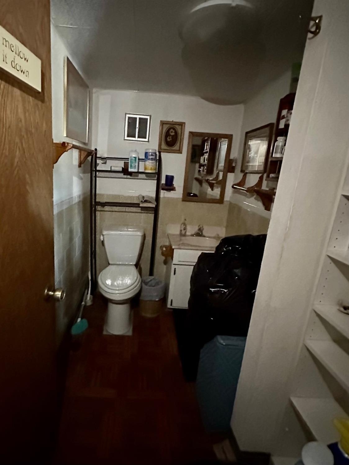 54758 Dinkey Creek Road Shaver Lake, CA 93664 - Photo 21 of 39 a room with a toilet a sink and a mirror