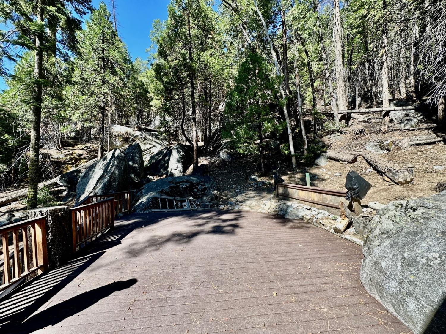 54758 Dinkey Creek Road Shaver Lake, CA 93664 - Photo 4 of 39 a view of a park with swings and slides
