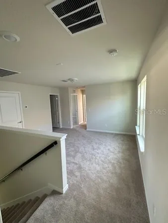 a view of a room with window and stairs