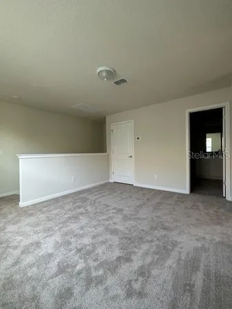 a view of an empty room and fire place