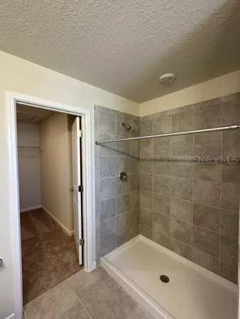 a bathroom with a granite countertop sink a toilet and a shower