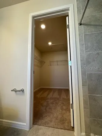 an empty room with windows and entrance