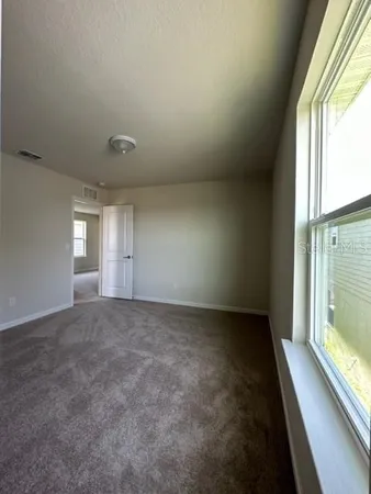 a view of an empty room and closet