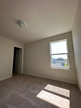 an empty room with a empty space and windows