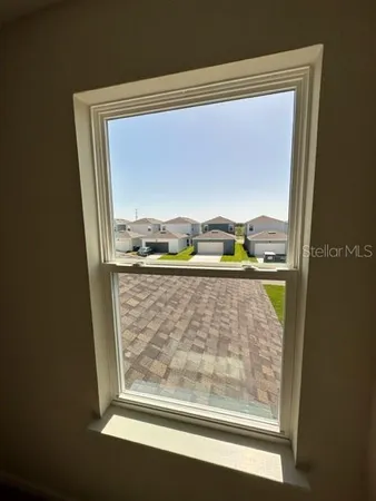 a view of an empty room with a window