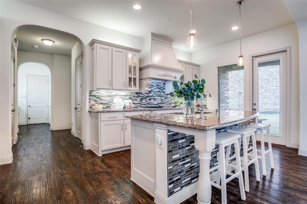 608 Arma Road Allen, TX 75002 - Photo 12 of 40 a kitchen with stainless steel appliances granite countertop a kitchen island a stove a cabinets and a sink