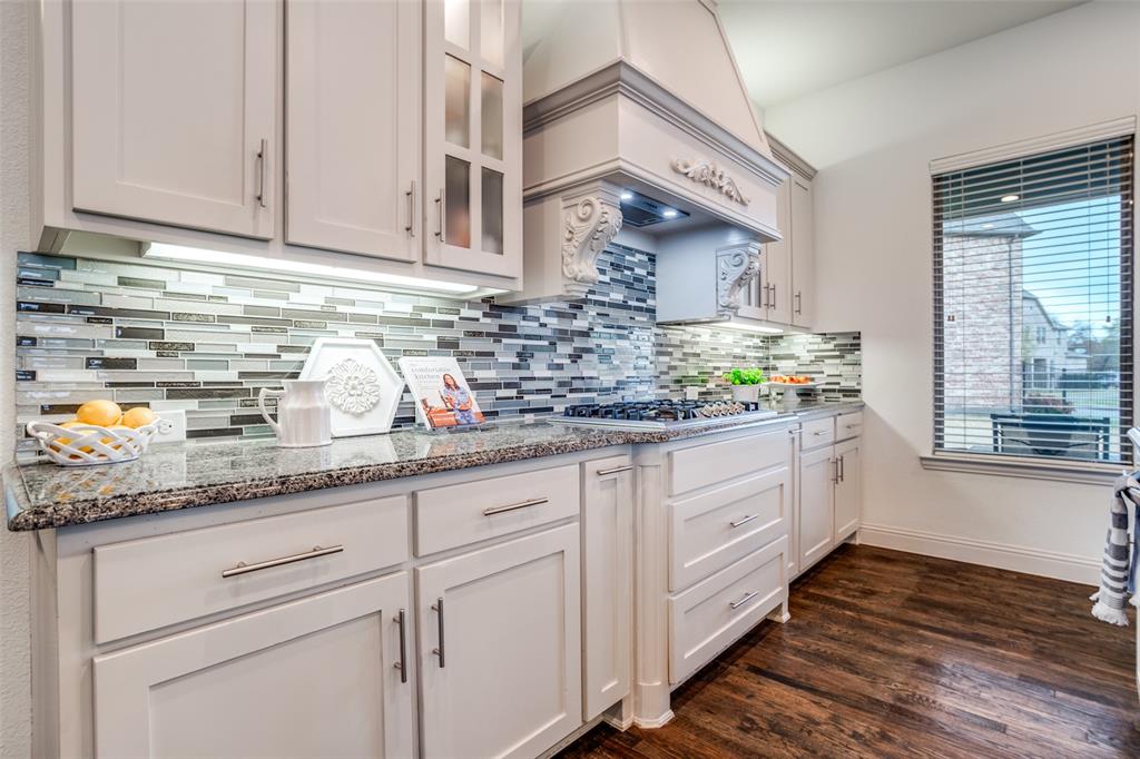 608 Arma Road Allen, TX 75002 - Photo 13 of 40 a kitchen with granite countertop white cabinets and white appliances