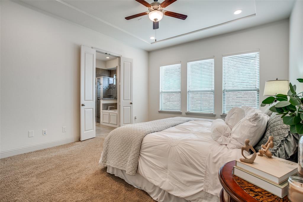 608 Arma Road Allen, TX 75002 - Photo 20 of 40 a bedroom with a bed and a chandelier