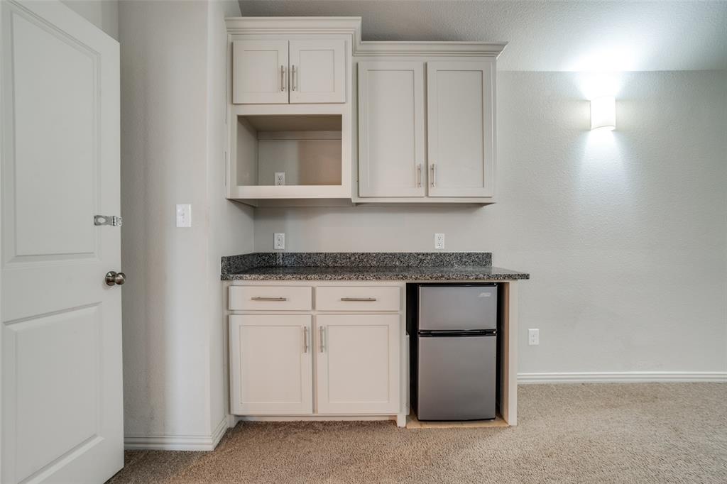 608 Arma Road Allen, TX 75002 - Photo 31 of 40 a kitchen with granite countertop white cabinets and a stove