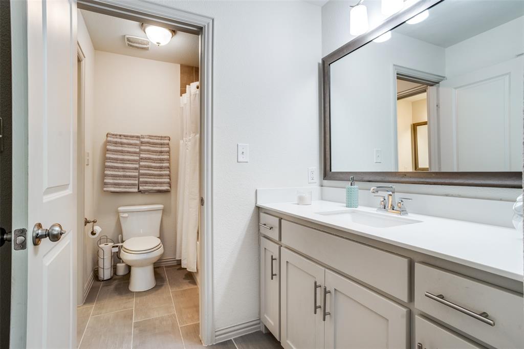608 Arma Road Allen, TX 75002 - Photo 33 of 40 a bathroom with a sink a toilet and a mirror