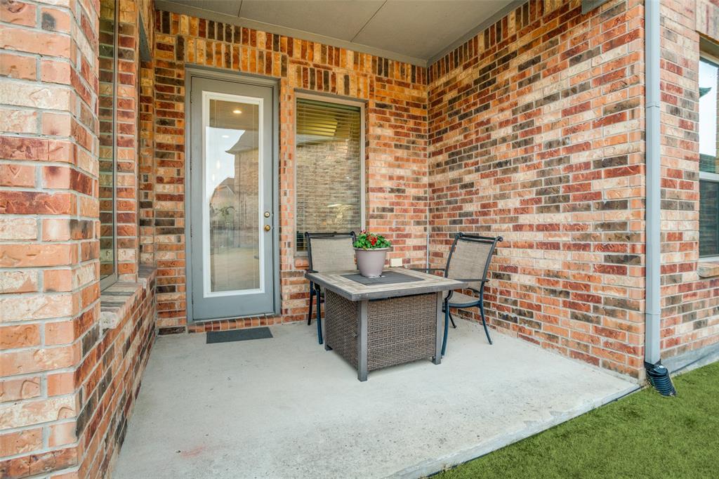 608 Arma Road Allen, TX 75002 - Photo 35 of 40 a view of a patio with a table and chairs and potted plants