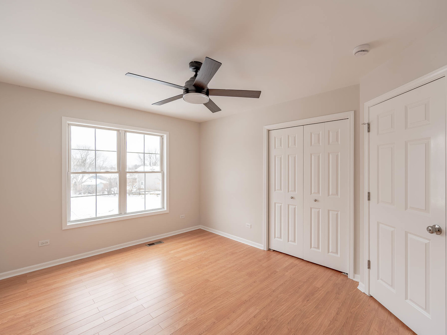 975 Merbach Court Carol Stream, IL 60188 - Photo 14 of 28 a view of empty room with wooden floor and fan
