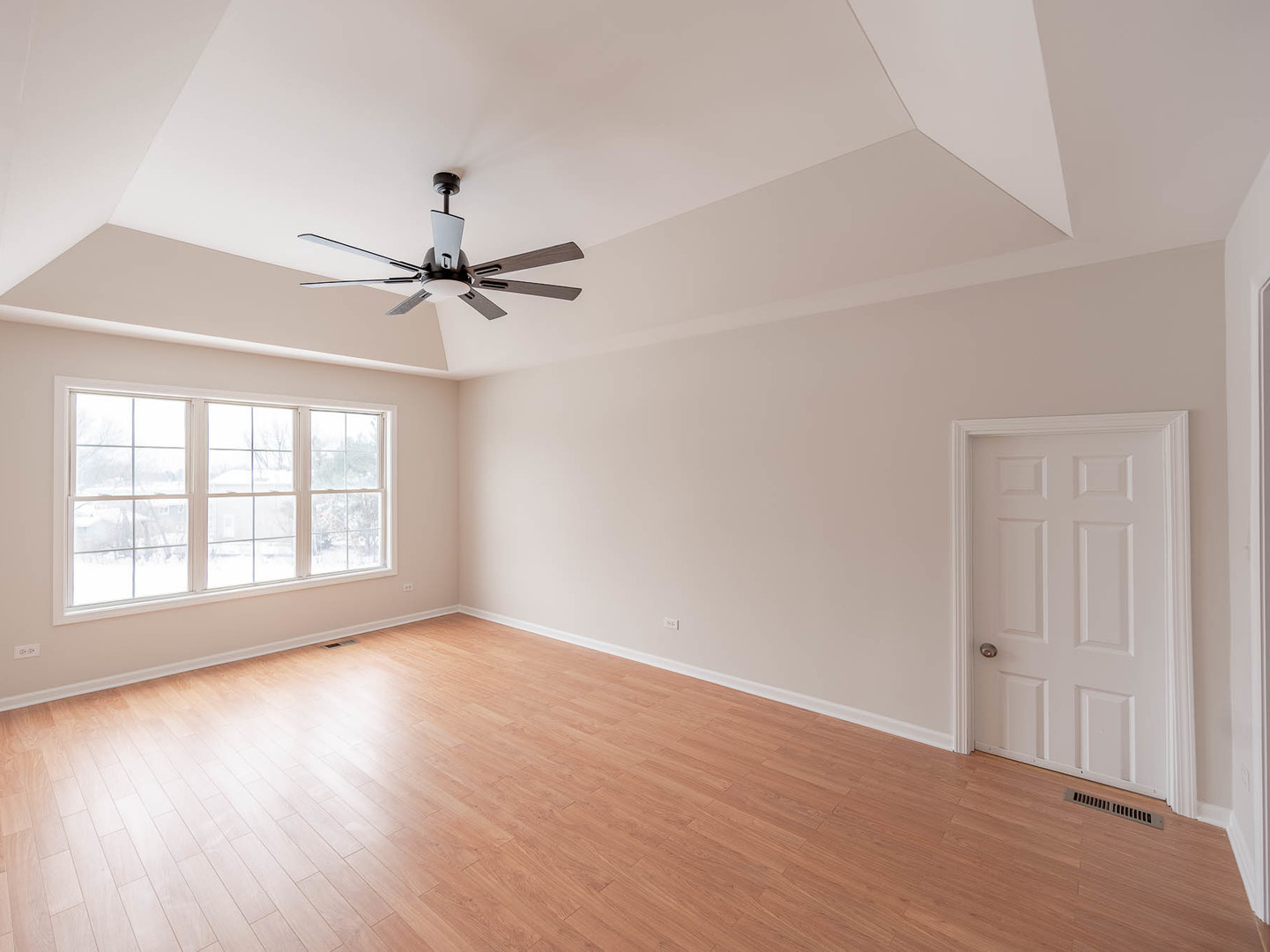 975 Merbach Court Carol Stream, IL 60188 - Photo 17 of 28 an empty room with wooden floor fan and windows