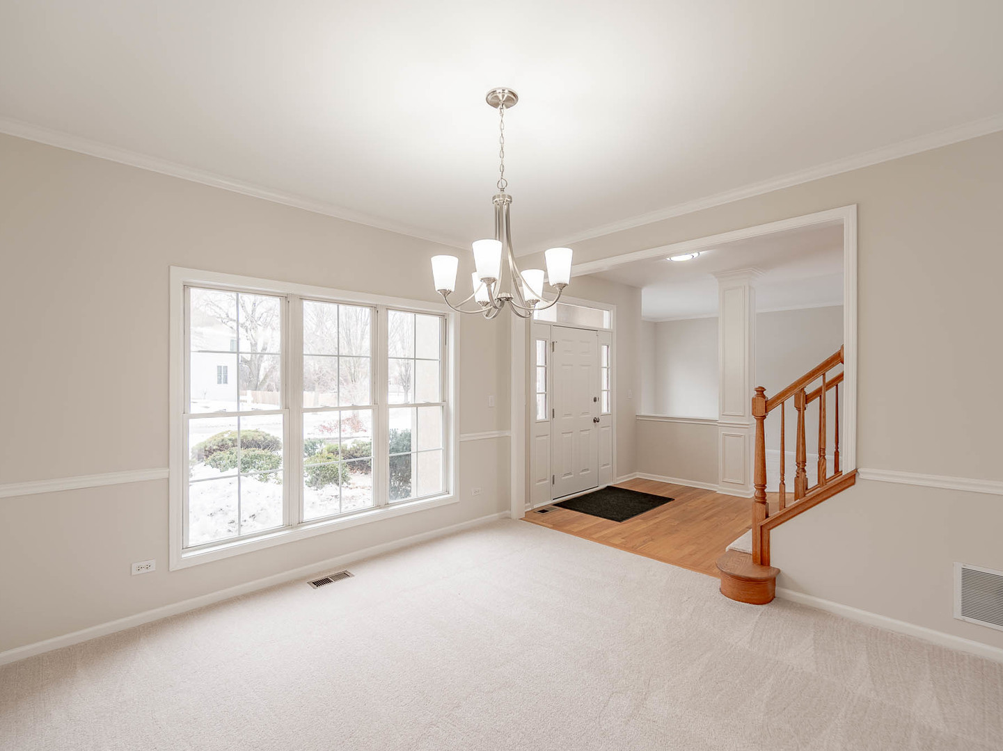 975 Merbach Court Carol Stream, IL 60188 - Photo 3 of 28 a view of an empty room with window chandelier fan