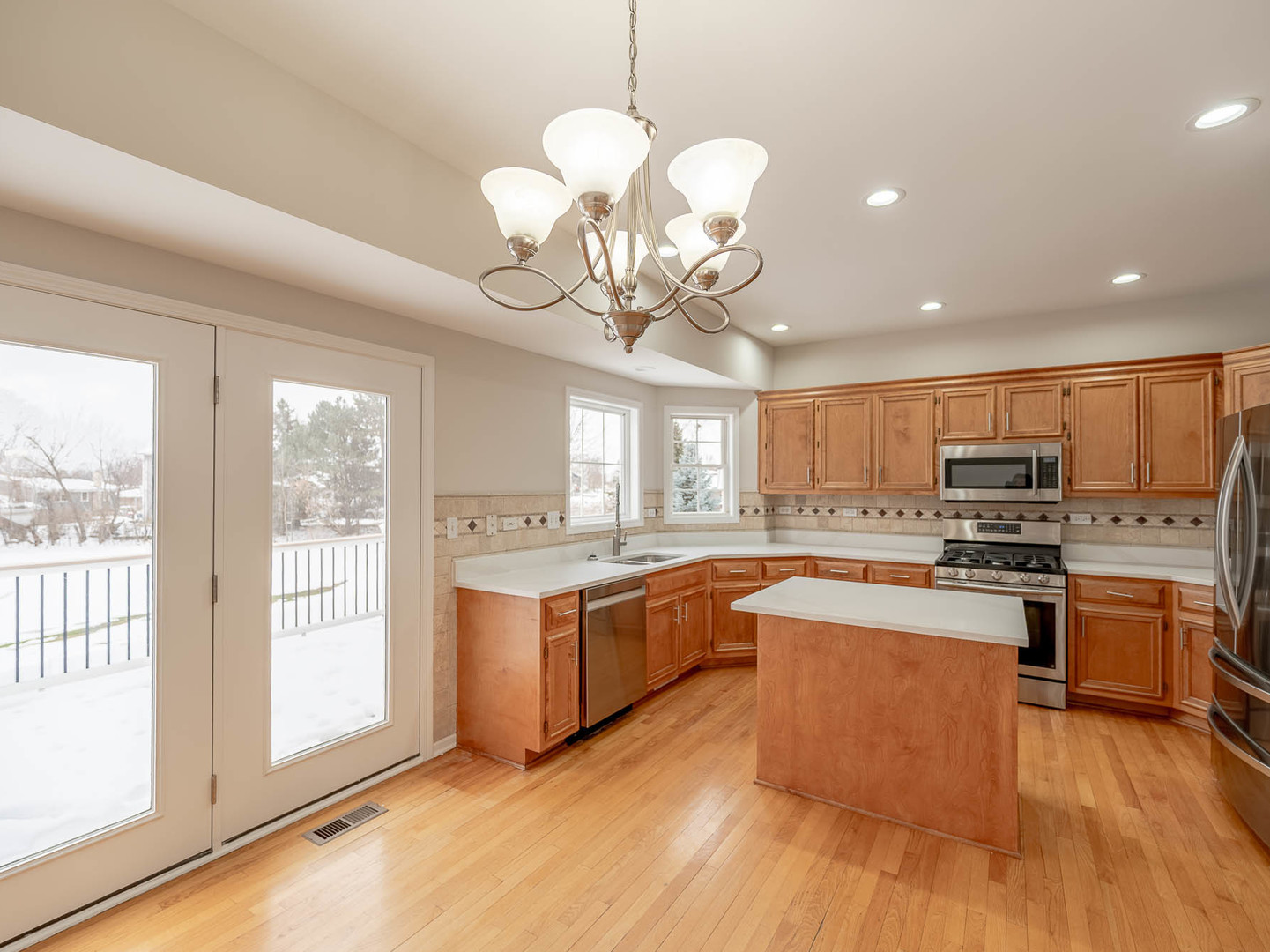 975 Merbach Court Carol Stream, IL 60188 - Photo 7 of 28 a large kitchen with stainless steel appliances granite countertop a stove and cabinets