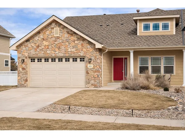 a view of a brick house with large windows