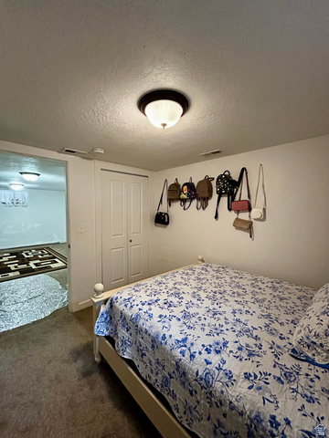 1931 Harrison Boulevard Ogden, UT 84401 - Photo 11 of 21 Bedroom #3 featuring wall-to-wall carpeting, bi-fold closet doors, and an overhead flush mount light fixture