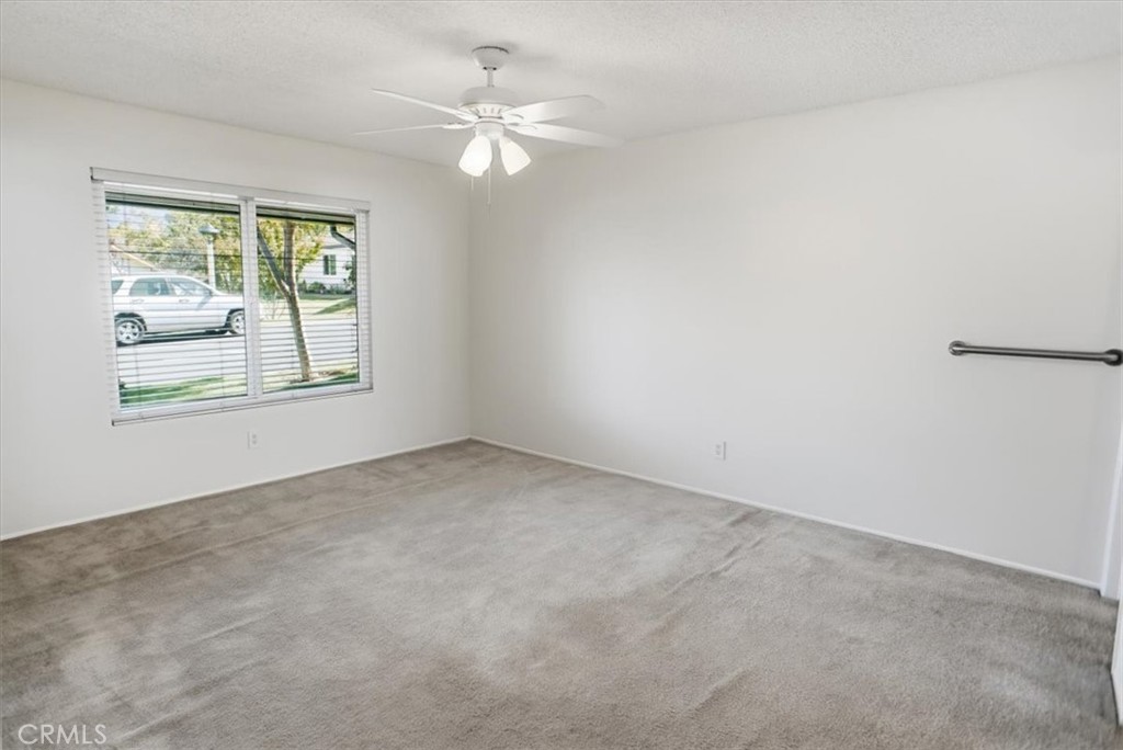 19427 Oak Crossing Road Newhall, CA 91321 - Photo 14 of 45 an empty room with windows and fan