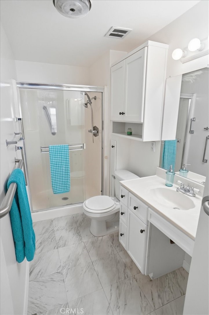 19427 Oak Crossing Road Newhall, CA 91321 - Photo 16 of 45 a bathroom with a sink a toilet and shower