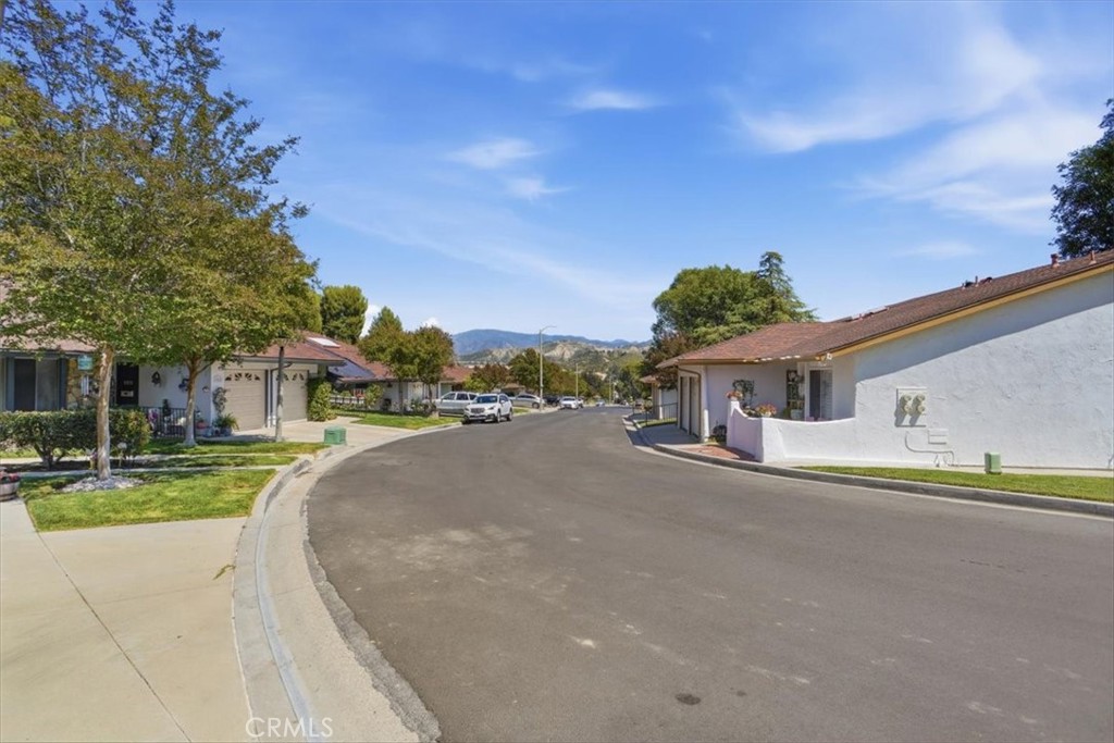 19427 Oak Crossing Road Newhall, CA 91321 - Photo 19 of 45 a front view of a house with a yard and trees