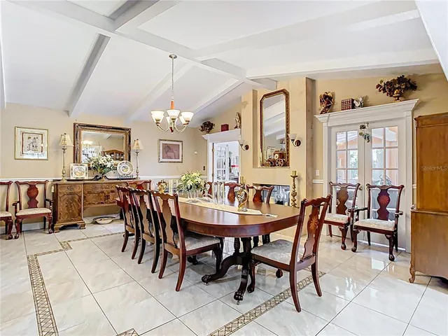 a living room with furniture a flat screen tv and a large window