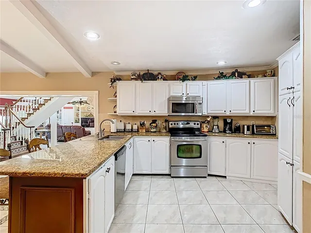 a living room with furniture a large window and a table