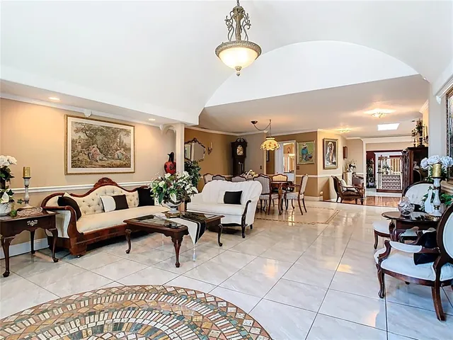 a living room with furniture gym equipment and a chandelier