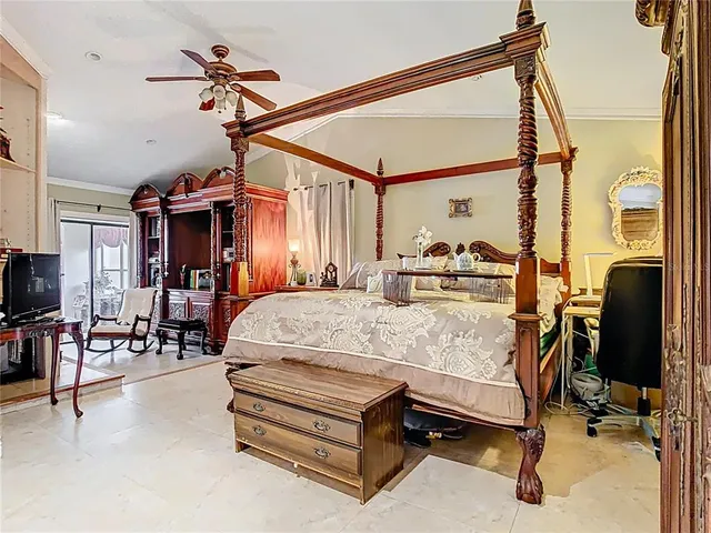 a bed room with a bed window and a flat screen tv