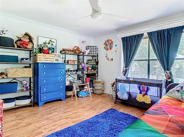 a view of a house with backyard and a tree