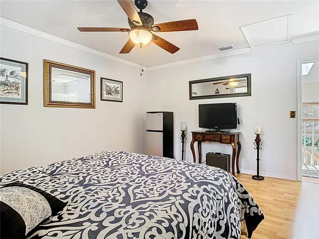 an aerial view of residential houses with outdoor space and trees