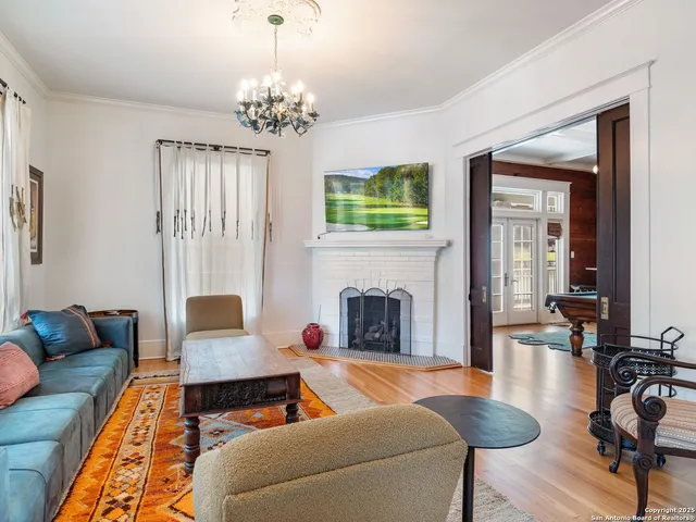 a living room with furniture and a chandelier