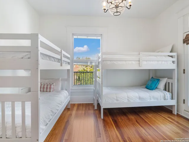 a bed room with a bed and a chandelier