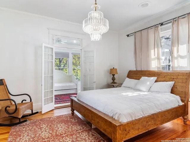 a bed sitting in a bedroom next to a window