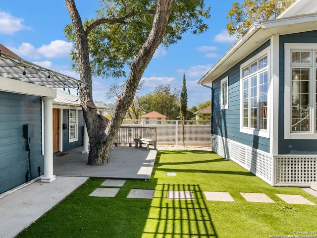 a view of a house with backyard and sitting area