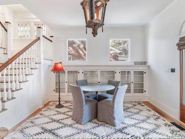 a dining room with furniture a chandelier and wooden floor
