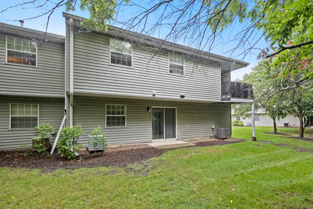 a view of a big yard with plants and large trees