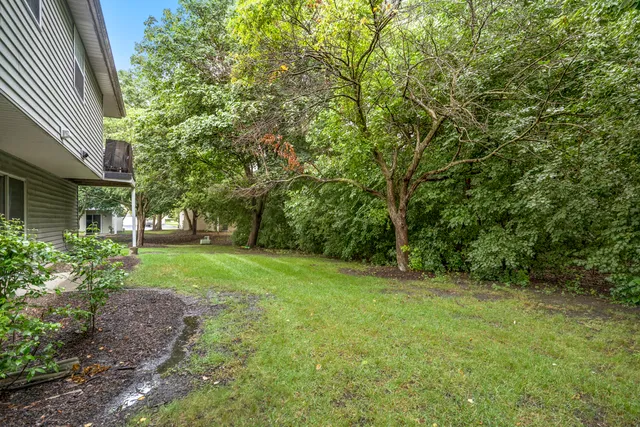 a front view of a house with a garden and yard