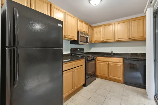 a kitchen with stainless steel appliances granite countertop a refrigerator sink and cabinets