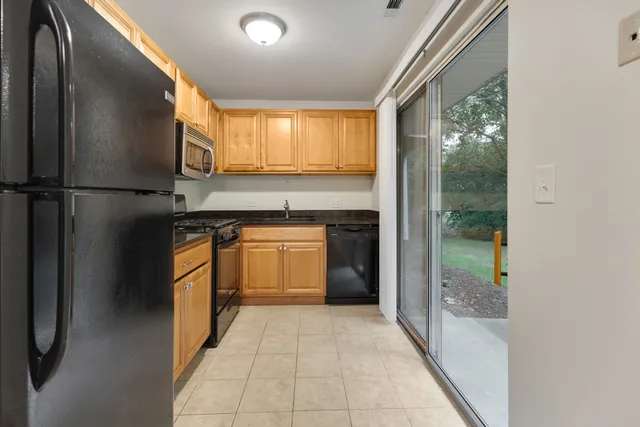 a kitchen with a refrigerator and a sink