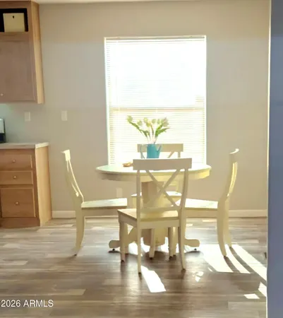 a view of a living room with a table and chairs
