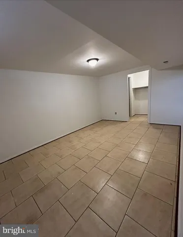 a view of an empty room and a window