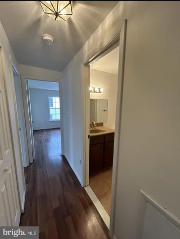 a view of a hallway and wooden floor