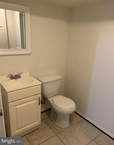 a white toilet sitting next to a bathroom sink