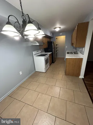 a kitchen with stainless steel appliances granite countertop a sink and a stove