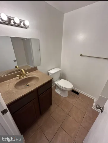 a bathroom with a sink toilet and mirror
