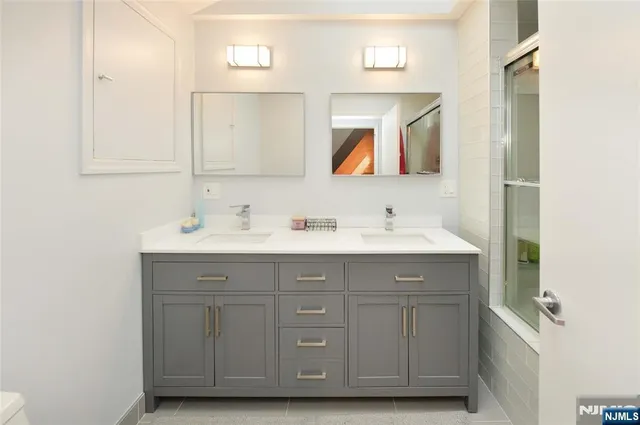 a bathroom with a sink vanity and mirror