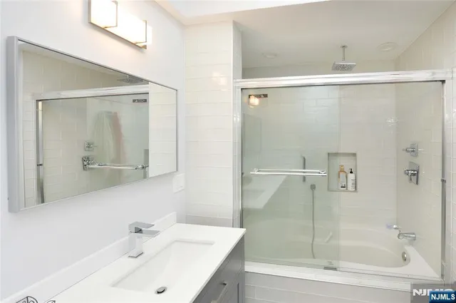 a bathroom with a shower and a sink