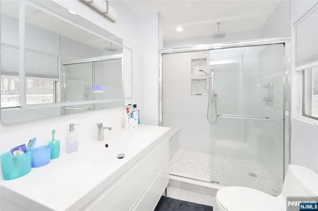 a bathroom with a sink toilet and shower